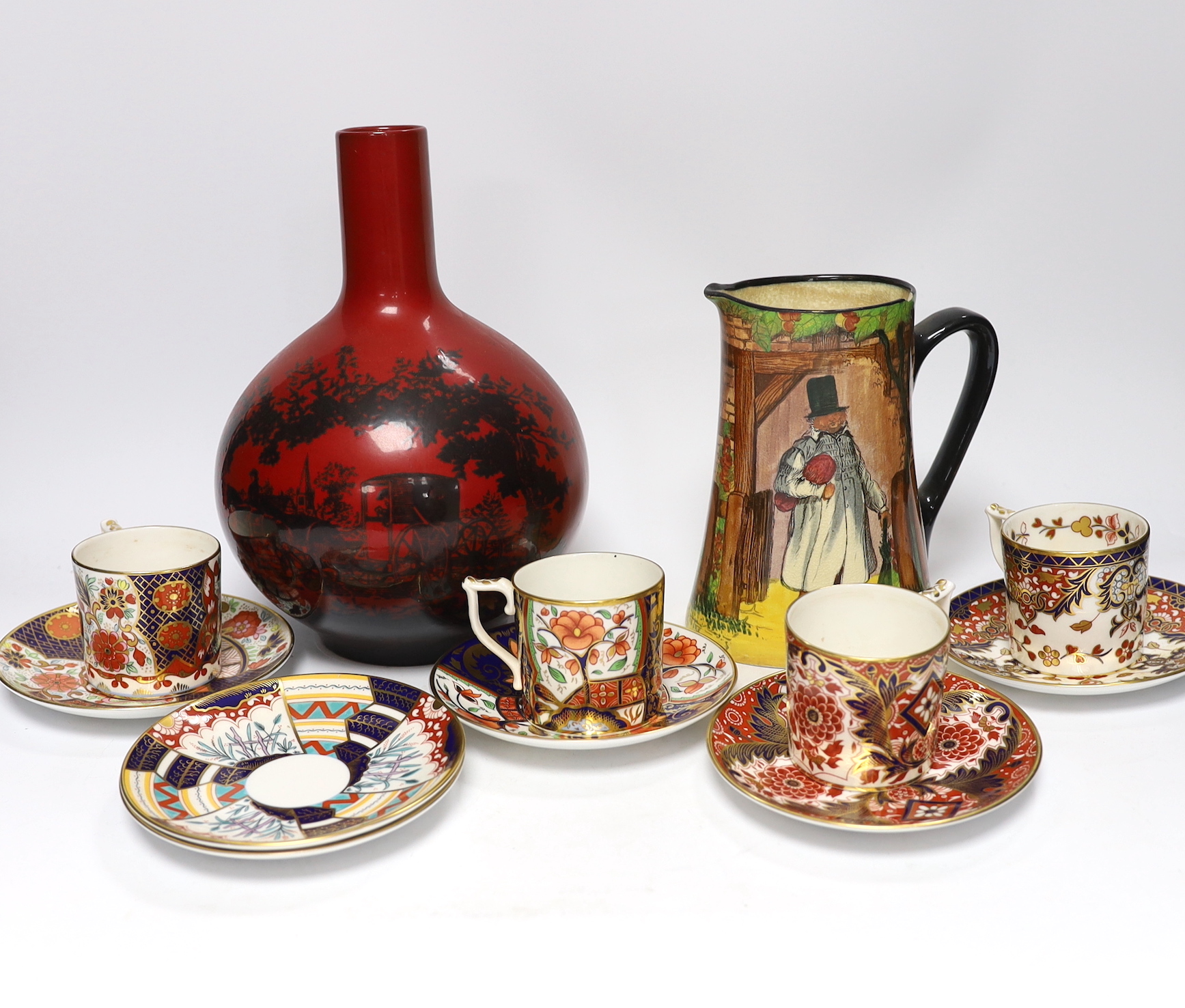 A Doulton flambé vase, a Gaffers Seriesware jug and Royal Crown Derby Imari cups and saucers, tallest 25.5cm